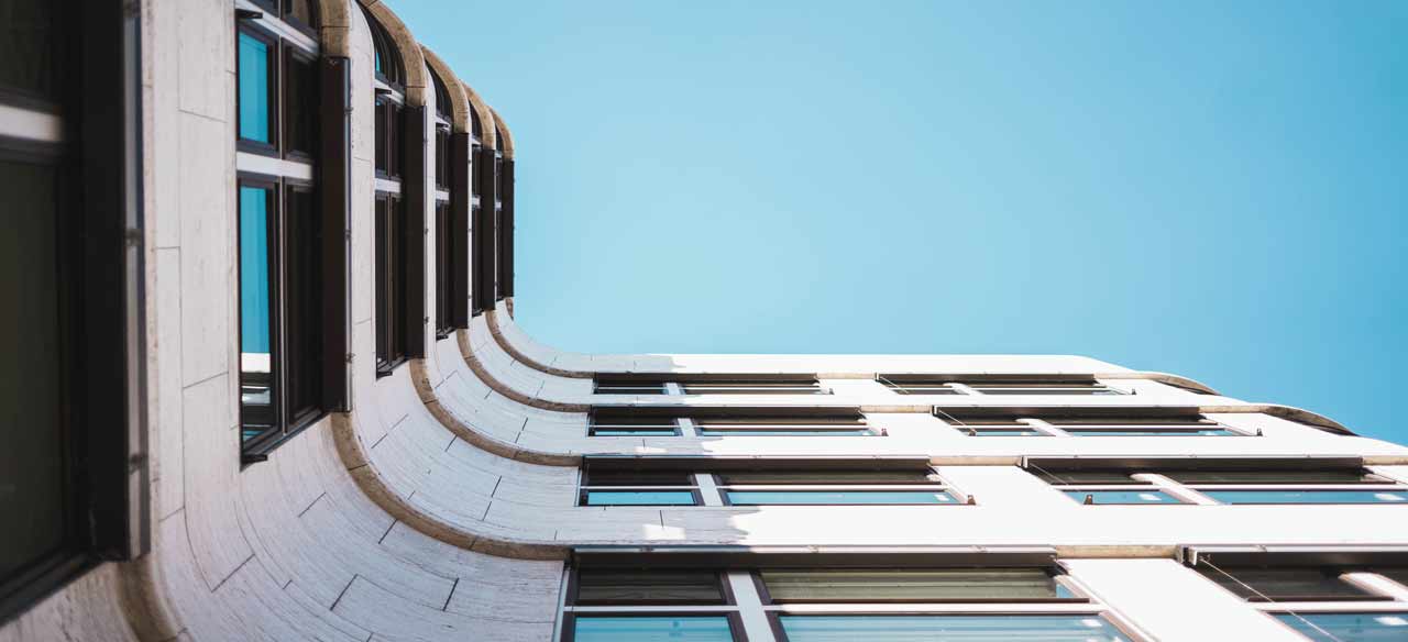 low-angle-shot-modern-building-with-large-glass-windows